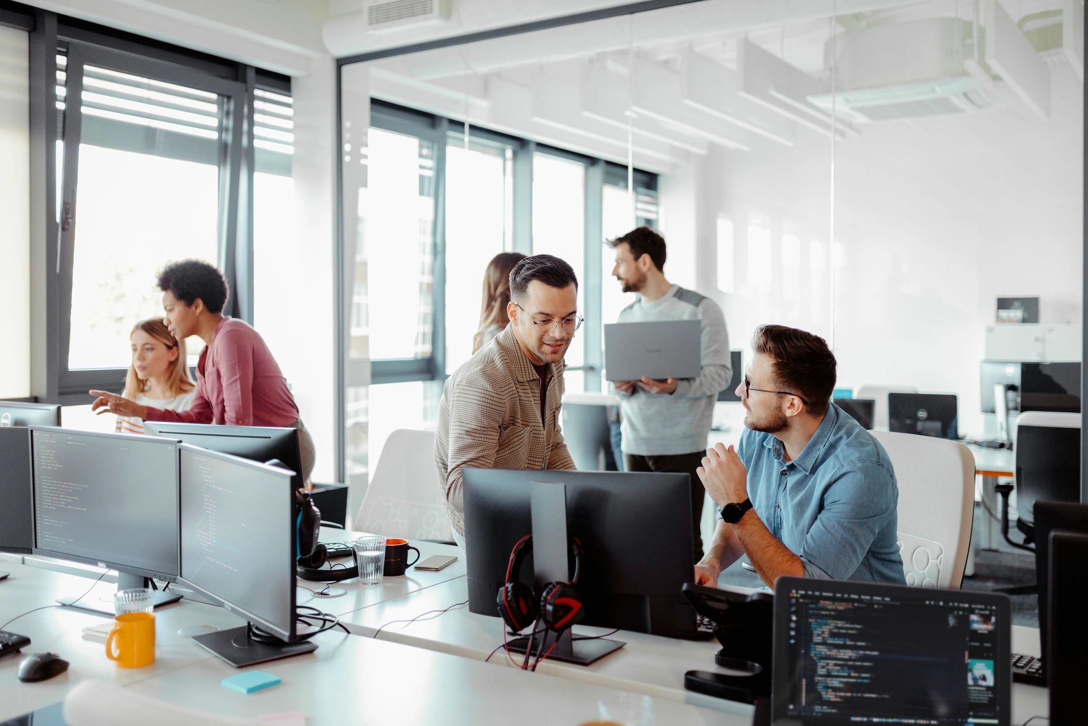 IT professionals collaborating on a technology solution in an office