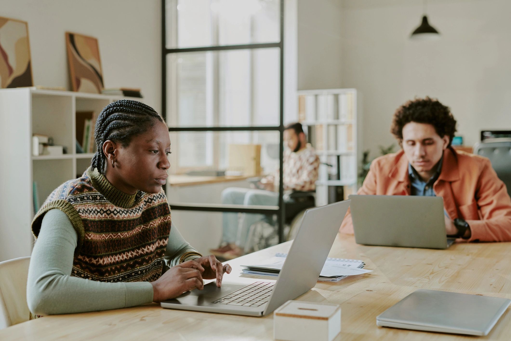 Software developers collaborating on laptops
